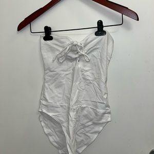 Sleeveless bodysuit. Color white, lace up. Size small.